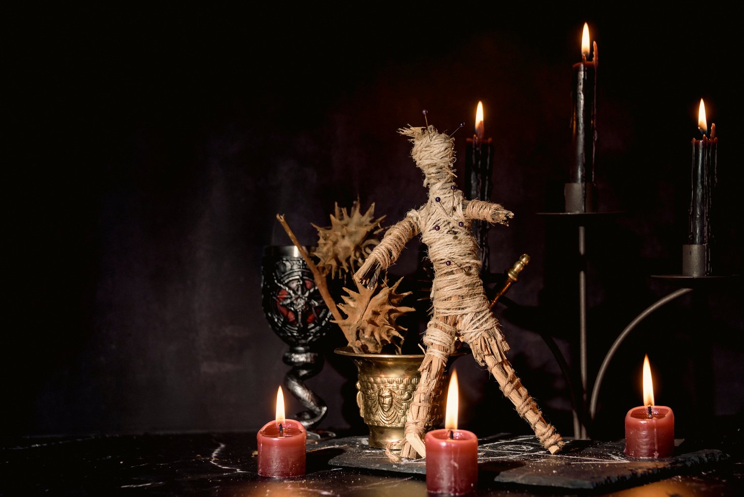 Voodoo Doll, Black Candles, Pentagram and Old Books on Witch Table. Occult, Esoteric, Divination and Wicca Concept. Mystic, Voodoo and Vintage Background.